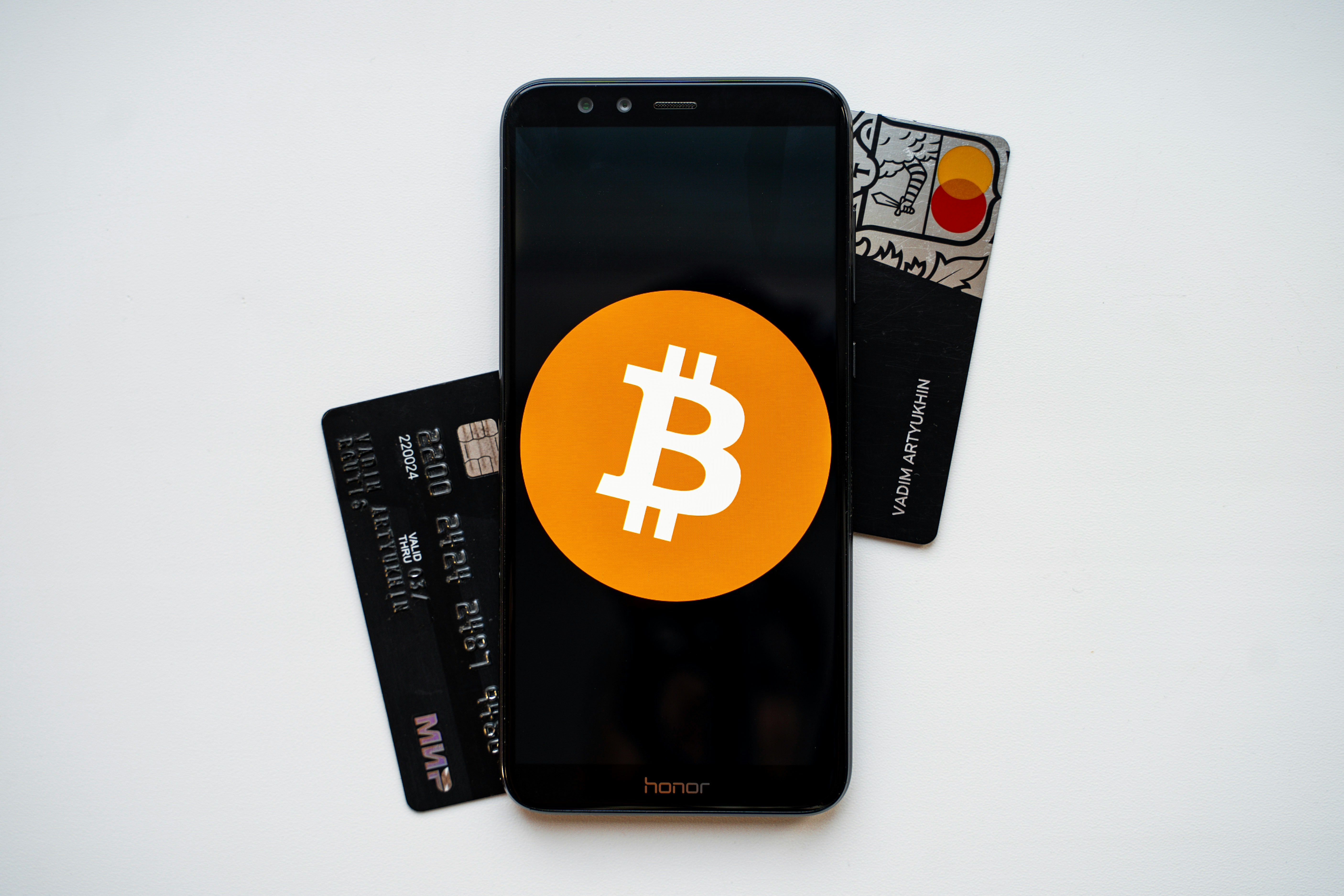 Bitcoin on a phone with bank cards